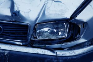 An Audi with front end damage to the grill and headlight